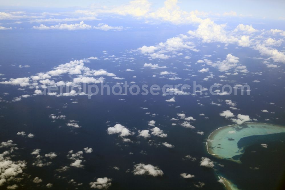 Aerial image Dharanboodhoo - Cumulus clouds overcast Coastal Indian Ocean - island in Dhahran Boodhoo in Central Province, Maldives