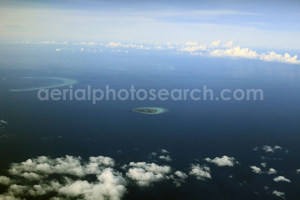 Aerial photograph Dharanboodhoo - Cumulus clouds overcast Coastal Indian Ocean - island in Dhahran Boodhoo in Central Province, Maldives