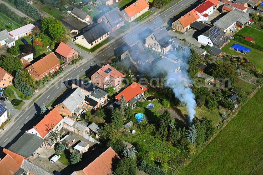 Solpke from above - Smoke and flames of a campfire in a garden at Krugende in Solpke in the state Saxony-Anhalt, Germany