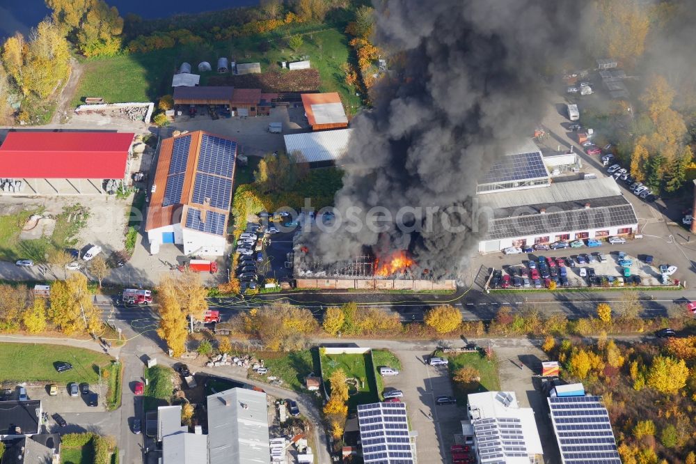 Aerial photograph Reinhardshagen - Smoke and flames during the fire fighting to fire einer Lagerhalle in Reinhardshagen - Vaake in the state Hesse, Germany