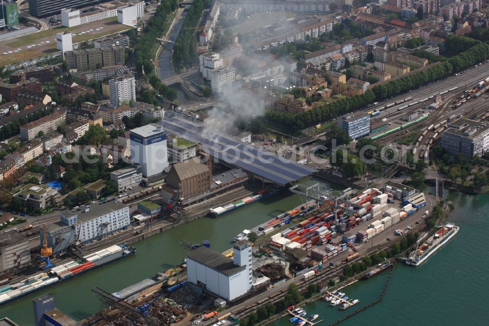 Aerial photograph Basel - Smoke and flames during the fire fighting to fire in the storage hall of logistics company Rhenus in Basel, Switzerland