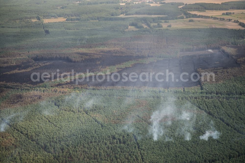 Treuenbrietzen from the bird's eye view: Smoke clouds by the Great Fire - destroyed forest fire tree population in a wooded area - forest terrain in Klausdorf in Treuenbrietzen in the state Brandenburg, Germany