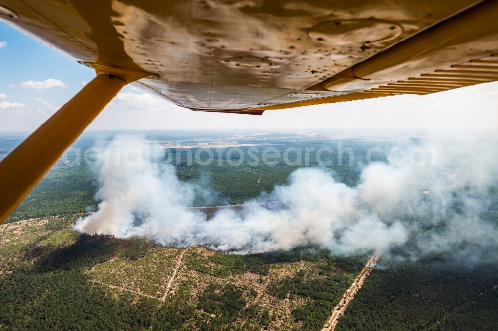 Jüterbog from the bird's eye view: Smoke clouds by the Great Fire - destroyed forest fire tree population in a wooded area - forest terrain in Jueterbog in the state Brandenburg, Germany