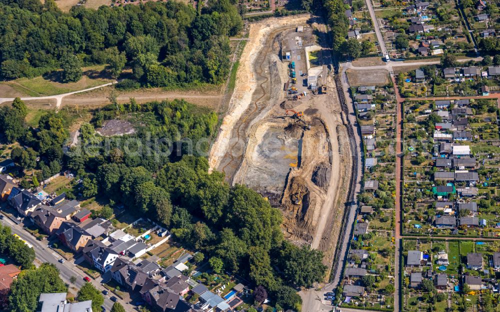 Essen from the bird's eye view: Construction site for the new construction of the retention basin and water storage at the Pausmuehlenbach next to the allotment garden settlement of the allotment garden association Weidkamp in the district Gerschede in Essen at Ruhrgebiet in the state North Rhine-Westphalia, Germany