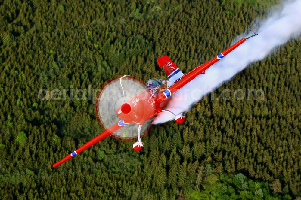 Untergschwend from the bird's eye view: Red Bull Air Race Pilot Matthias Dolderer während eines Fluges mit einem Flugzeug / Kleinflugzeug vom Typ Extra 330SC mit der Kennung D-EXMD über Untergschwend / Bayern. Red Bull Air Race Pilot Matthias Dolderer during a flight with a smal aircraft / plan near by the village Untergschwend / Bavaria.