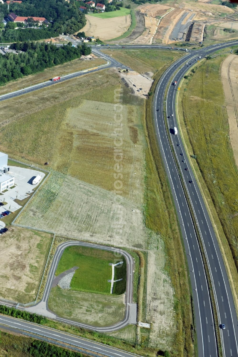 Borna from the bird's eye view: Rainwater retention basins and fire water pond aloung the Highway- Construction site with earthworks along the route and of the route of the highway route B95 to A72 motorway in Borna in the state Saxony