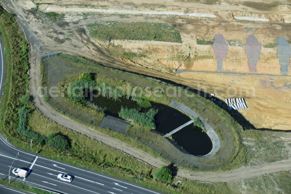 Aerial image Borna - Rainwater retention basins and fire water pond aloung the Highway- Construction site with earthworks along the route and of the route of the highway route B95 to A72 motorway in Borna in the state Saxony