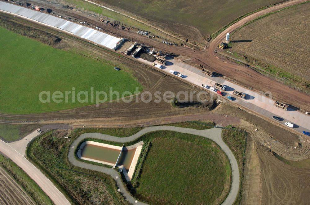 Aerial photograph Sättelstädt - Blick auf ein Regenrückhaltbecken VI nahe der Baustelle der Ausfahrt / Anschlussstelle Sättelstädt der A4. Der Neubau ist Teil des Projekt Nordverlegung / Umfahrung Hörselberge der Autobahn E40 / A4 in Thüringen bei Eisenach. Durchgeführt werden die im Zuge dieses Projektes notwendigen Arbeiten unter an derem von den Mitarbeitern der Niederlassung Weimar der EUROVIA Verkehrsbau Union sowie der Niederlassungen Abbruch und Erdbau, Betonstraßenbau, Ingenieurbau und TECO Schallschutz der EUROVIA Beton sowie der DEGES.