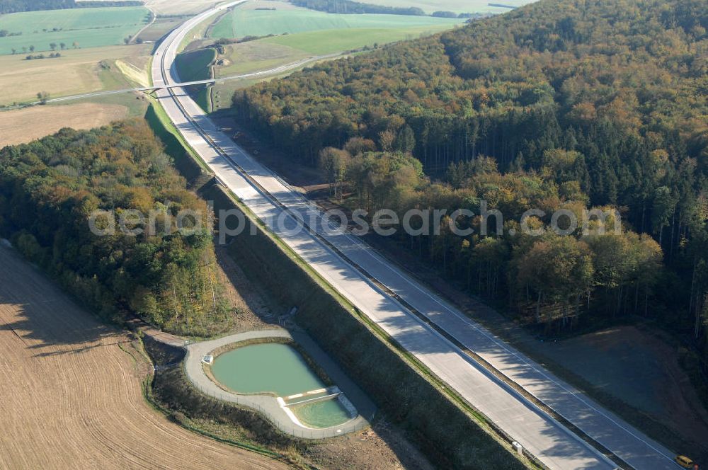 Aerial image Madelungen - Blick auf ein Regenrückhaltebecken neben der A4 nahe der Unterführung südlich von Madelungen im Madelungener Forst. Der Neubau ist Teil des Projekt Nordverlegung / Umfahrung Hörselberge der Autobahn E40 / A4 in Thüringen bei Eisenach. Durchgeführt werden die im Zuge dieses Projektes notwendigen Arbeiten unter an derem von den Mitarbeitern der Niederlassung Weimar der EUROVIA Verkehrsbau Union sowie der Niederlassungen Abbruch und Erdbau, Betonstraßenbau, Ingenieurbau und TECO Schallschutz der EUROVIA Beton sowie der DEGES.