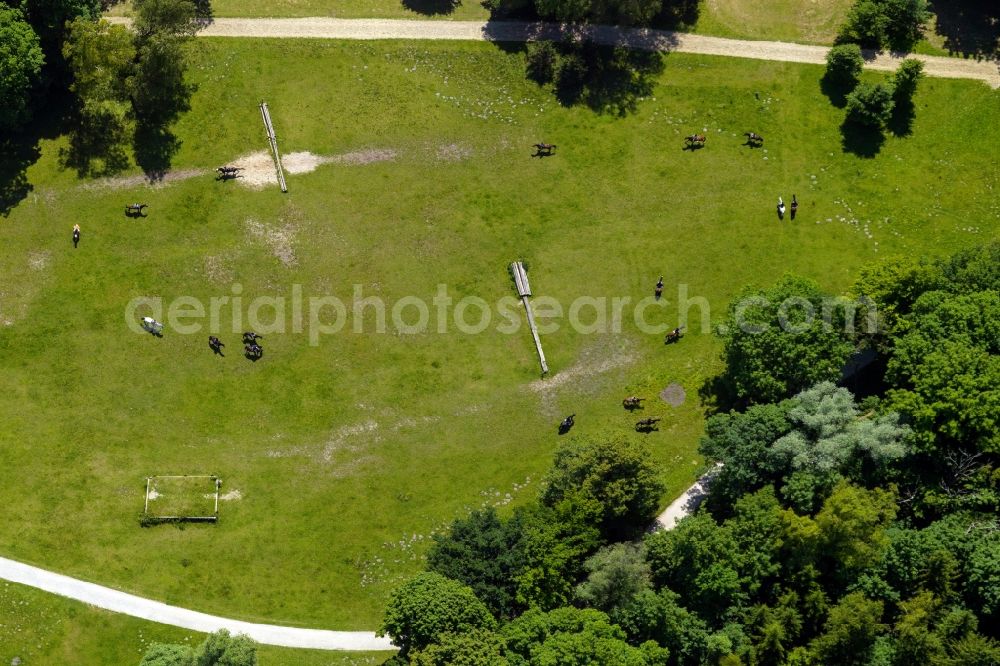 München from above - Riders and horses on a meadow and lawn area of the English Garden in Munich in the state of Bavaria