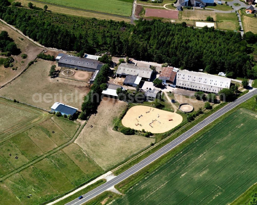 Hungenroth from above - Horse stables Carmen Dingler Reitanlage in the borough of Hungenroth in the state of Rhineland-Palatinate. The compound includes stables and horse riding facilities and is located on federal motorway A61