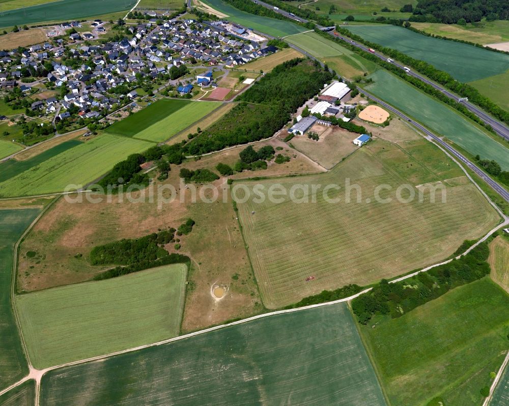 Aerial image Hungenroth - Horse stables Carmen Dingler Reitanlage in the borough of Hungenroth in the state of Rhineland-Palatinate. The compound includes stables and horse riding facilities and is located on federal motorway A61