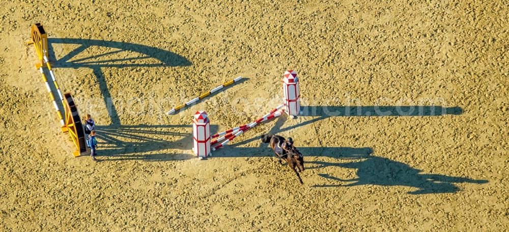 Aerial image Hamm - Building of stables with obstacle training with long shadows at the riding Rhynern in Hamm in the state North Rhine-Westphalia