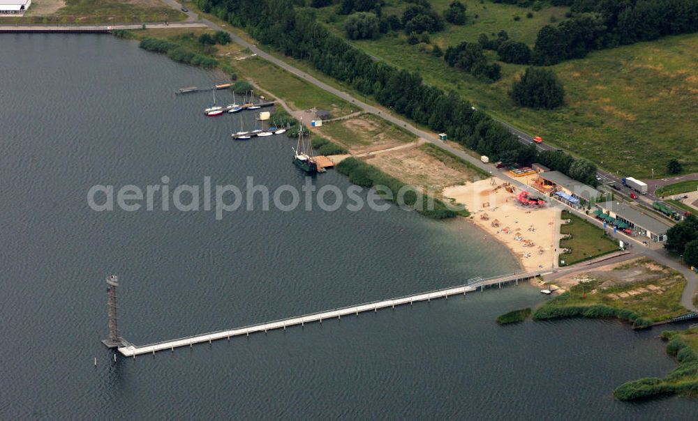 Bitterfeld from the bird's eye view: Blick auf die Rekultivierungsfläche am Bernsteinsee in Bitterfeld.Das Gelände an der B100 in Richtung Goitzsche wird geschückt durch ein Anwesen, das den phantasievollen Namen „Villa am Bernsteinsee“ trägt. Die ehemals „Biermannsche Villa“ wurde 1896 im prunkvollen Stil der Neorenaissance errichtet. View of the reclamation area on Bernsteinsee in Bitterfeld.