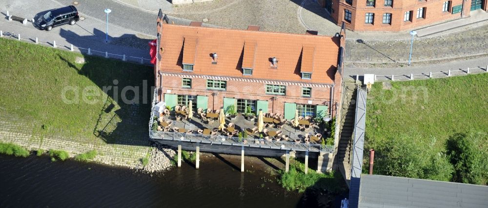 Aerial image Wittenberge - 07/08/2012 Wittenberge View the Crane House restaurant on the banks of the Elbe in Wittenberg in the state of Brandenburg. The old warehouse is made ??after extensive restoration and renovation zeitgerechtem an attraction for tourism in the region