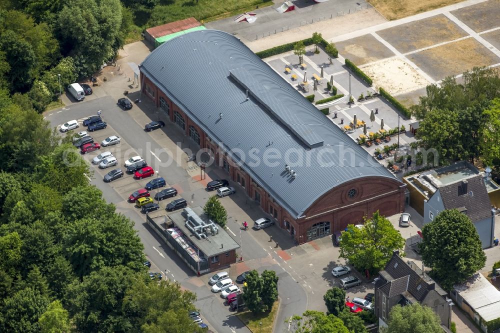 Aerial photograph Schwerte - Restaurant and event location Rohrmeisterei in the South of Schwerte in the state of North Rhine-Westphalia. The compound includes the historic main building with the semi-circular roof and a large open-air area. The compound is surrounded by forest and meadows