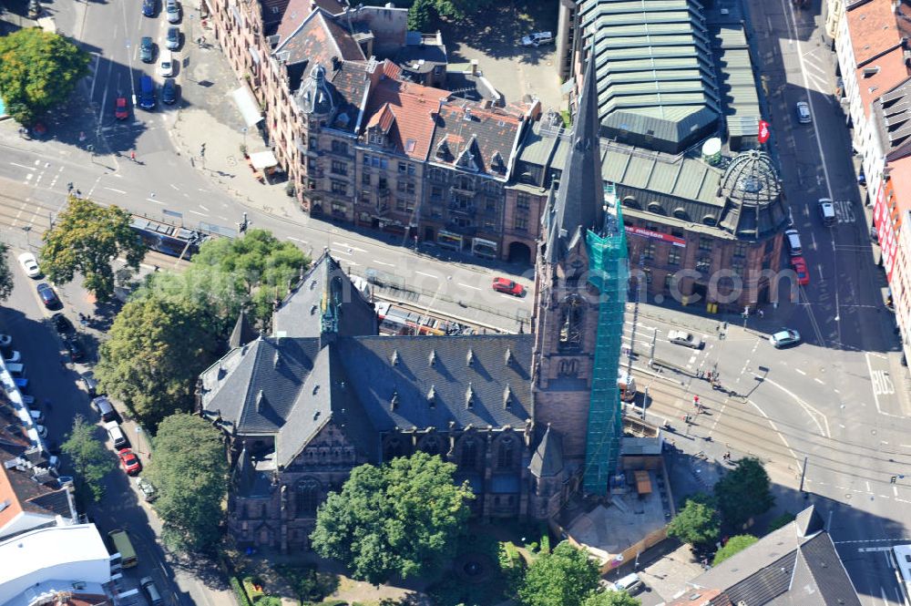 Aerial image Saarbrücken - Restaurierungsarbeiten am Turm der evangelischen Johanneskirche in Saarbrücken im Saarland. Die neugotische Kirche wurde um 1895 vom Architekten Heinrich Güth erbaut. Sie steht im Saarbrückener Stadtteil St. Johann, gegenüber dem Rathausplatz. Renovation works on evangelical church Johanneskirche in city Saarbrücken in Saarland. The neo-Gothic church was built around 1895 by architect Heinrich Güth. It is located in district St. Johann, in opposition to the townhall square.