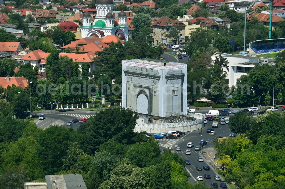 Bukarest from above - The restoration and rehabilitation work on the Arcul de Triumf, the triumph arch in the Romanian capital Bucharest in Romania. The landmark on the star-shaped roundabout tapering of Piata Arcul de Triumf is currently covered with a to-scale printed tarpaulin to protect the sandblasting and restoration work