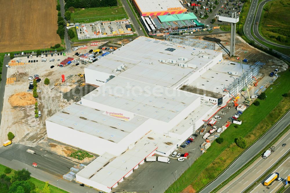 Fredersdorf-Vogelsdorf from above - Revitalization and expansion construction site at the building complex Moebel Hoeffner as part of the shopping center Multicenter Vogelsdorf on Frankfurter Chaussee in Fredersdorf-Vogelsdorf in the federal state of Brandenburg, Germany