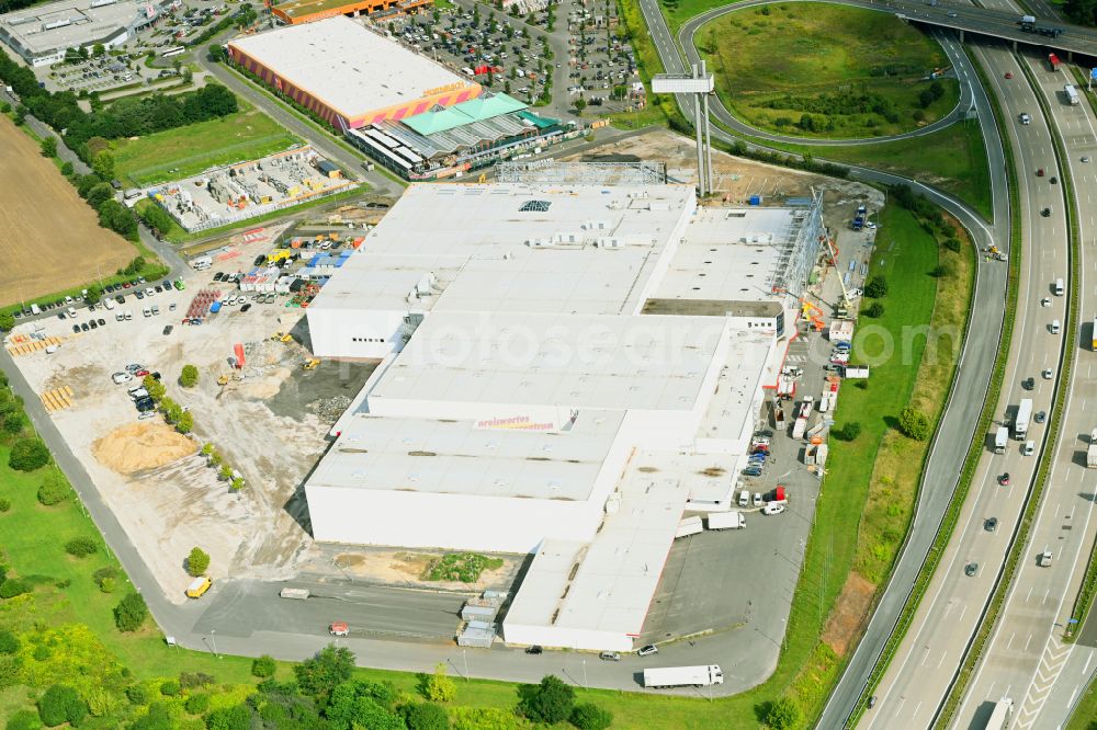 Fredersdorf-Vogelsdorf from the bird's eye view: Revitalization and expansion construction site at the building complex Moebel Hoeffner as part of the shopping center Multicenter Vogelsdorf on Frankfurter Chaussee in Fredersdorf-Vogelsdorf in the federal state of Brandenburg, Germany