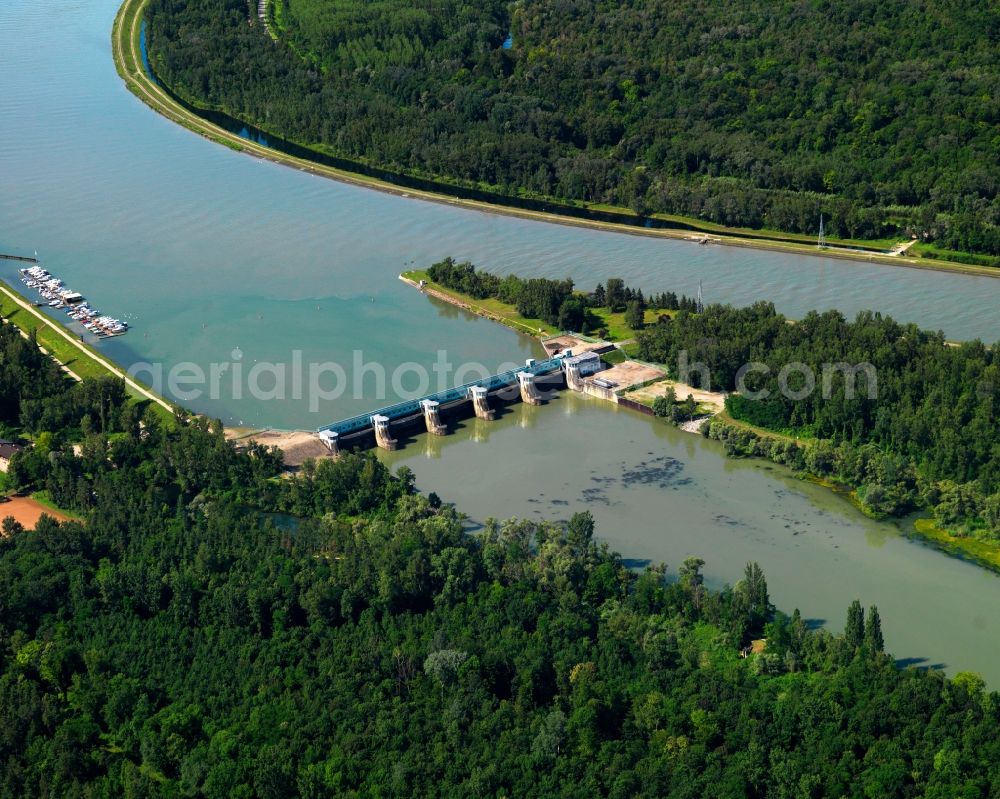 Vogtsburg im Kaiserstuhl from above - Dam of the Rhine in Vogtsburg im Kaiserstuhl in the state of Baden-Wuerttemberg. The dam is located next to the Burkheim part of the town on a side-arm of the river which is the border to France. The dam connects Germany and a large Rhine island. In close vicinity, there is a boat dock