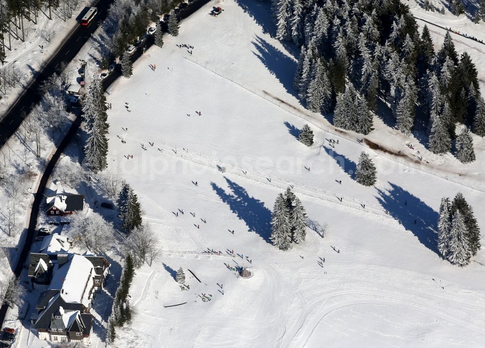 Oberhof from above - People on the wintry, snowy sledding hill in Oberhof in Thuringia