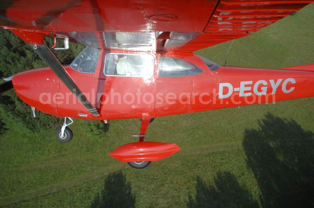 Werneuchen from above - Bright red Cessna 172 D-EGYC of the agency euroluftbild.de in flight over the airfield in Werneuchen in the state Brandenburg, Germany