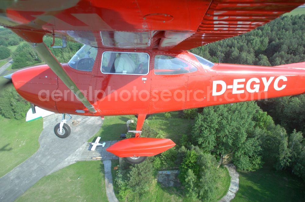 Aerial image Werneuchen - Bright red Cessna 172 D-EGYC of the agency euroluftbild.de in flight over the airfield in Werneuchen in the state Brandenburg, Germany