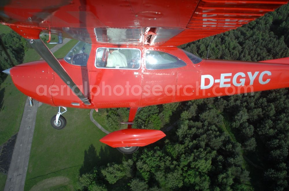 Werneuchen from above - Bright red Cessna 172 D-EGYC of the agency euroluftbild.de in flight over the airfield in Werneuchen in the state Brandenburg, Germany