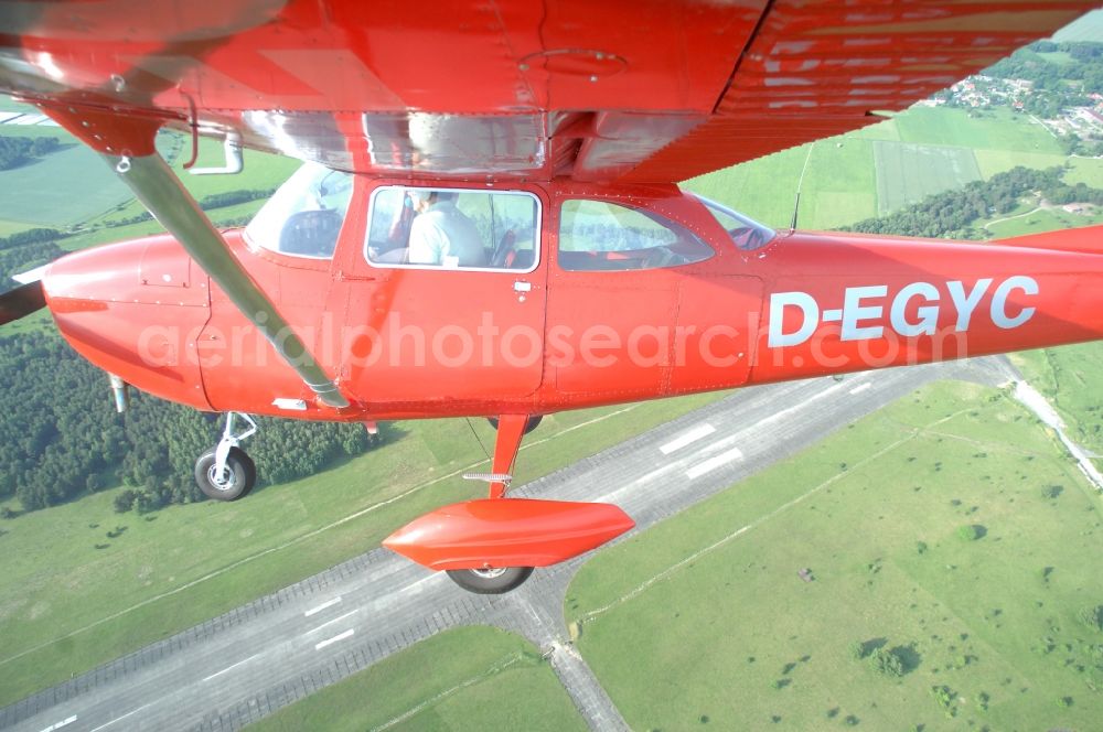 Aerial image Werneuchen - Bright red Cessna 172 D-EGYC of the agency euroluftbild.de in flight over the airfield in Werneuchen in the state Brandenburg, Germany