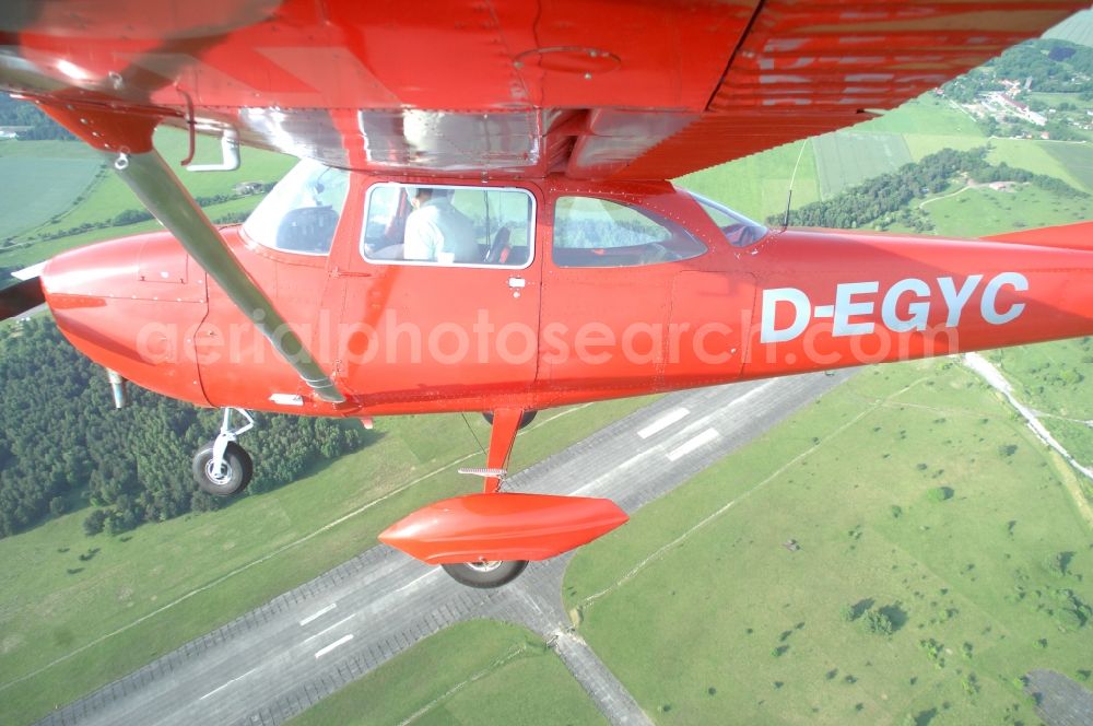 Aerial photograph Werneuchen - Bright red Cessna 172 D-EGYC of the agency euroluftbild.de in flight over the airfield in Werneuchen in the state Brandenburg, Germany