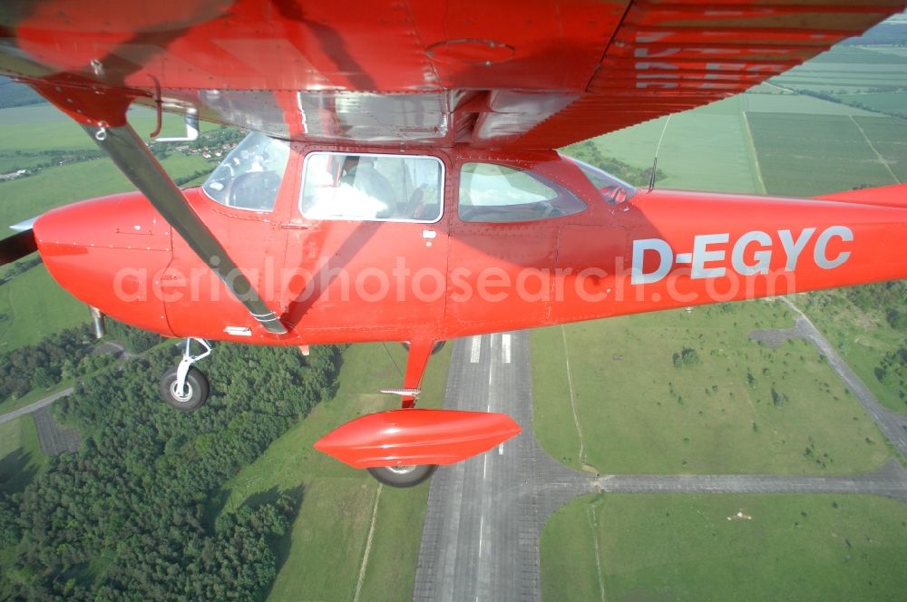 Werneuchen from above - Bright red Cessna 172 D-EGYC of the agency euroluftbild.de in flight over the airfield in Werneuchen in the state Brandenburg, Germany