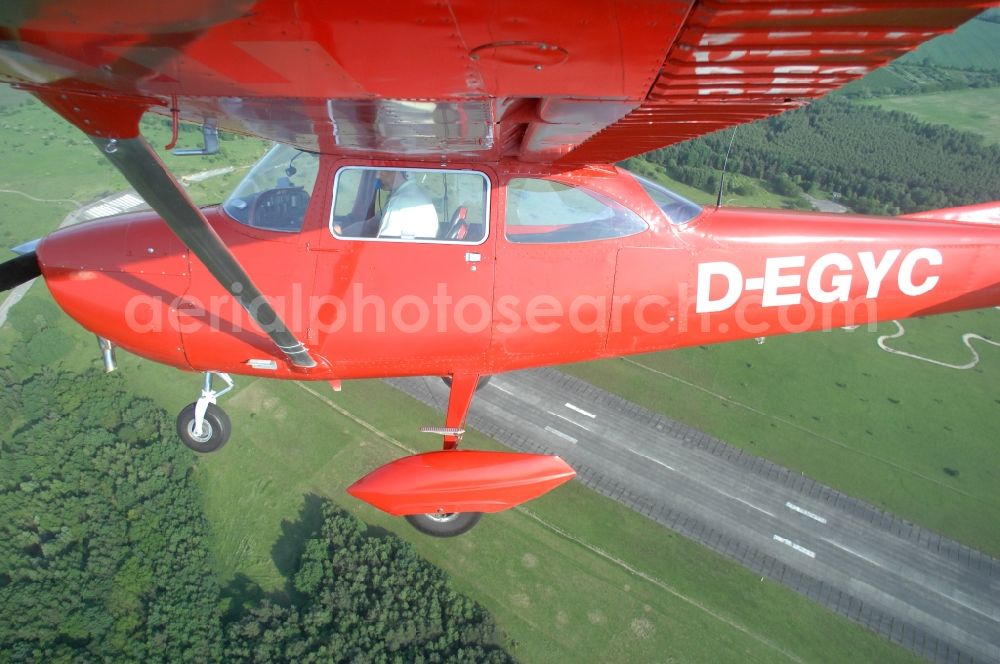 Aerial image Werneuchen - Bright red Cessna 172 D-EGYC of the agency euroluftbild.de in flight over the airfield in Werneuchen in the state Brandenburg, Germany