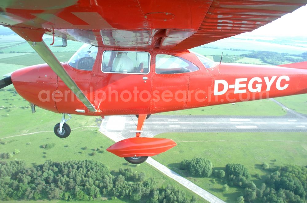 Aerial photograph Werneuchen - Bright red Cessna 172 D-EGYC of the agency euroluftbild.de in flight over the airfield in Werneuchen in the state Brandenburg, Germany