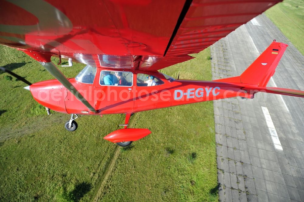 Werneuchen from above - Bright red Cessna 172 D-EGYC of the agency euroluftbild.de in flight over the airfield in Werneuchen in the state Brandenburg, Germany