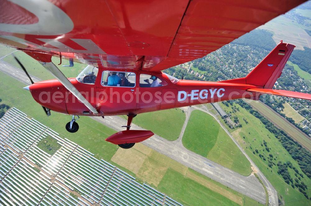 Werneuchen from above - Bright red Cessna 172 D-EGYC of the agency euroluftbild.de in flight over the airfield in Werneuchen in the state Brandenburg, Germany