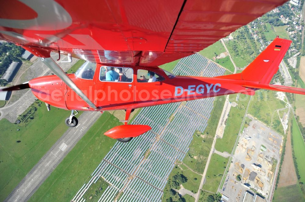 Aerial photograph Werneuchen - Bright red Cessna 172 D-EGYC of the agency euroluftbild.de in flight over the airfield in Werneuchen in the state Brandenburg, Germany