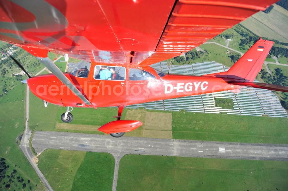 Aerial image Werneuchen - Bright red Cessna 172 D-EGYC of the agency euroluftbild.de in flight over the airfield in Werneuchen in the state Brandenburg, Germany