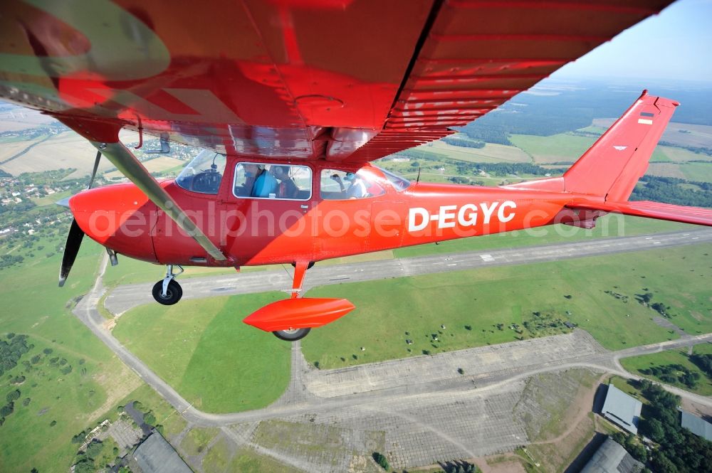 Aerial image Werneuchen - Bright red Cessna 172 D-EGYC of the agency euroluftbild.de in flight over the airfield in Werneuchen in the state Brandenburg, Germany