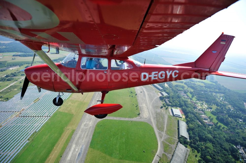 Werneuchen from above - Bright red Cessna 172 D-EGYC of the agency euroluftbild.de in flight over the airfield in Werneuchen in the state Brandenburg, Germany