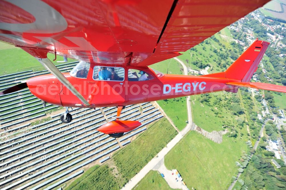 Aerial image Werneuchen - Bright red Cessna 172 D-EGYC of the agency euroluftbild.de in flight over the airfield in Werneuchen in the state Brandenburg, Germany