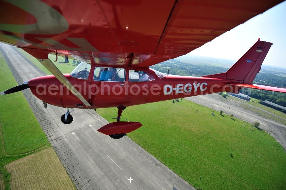 Aerial photograph Werneuchen - Bright red Cessna 172 D-EGYC of the agency euroluftbild.de in flight over the airfield in Werneuchen in the state Brandenburg, Germany