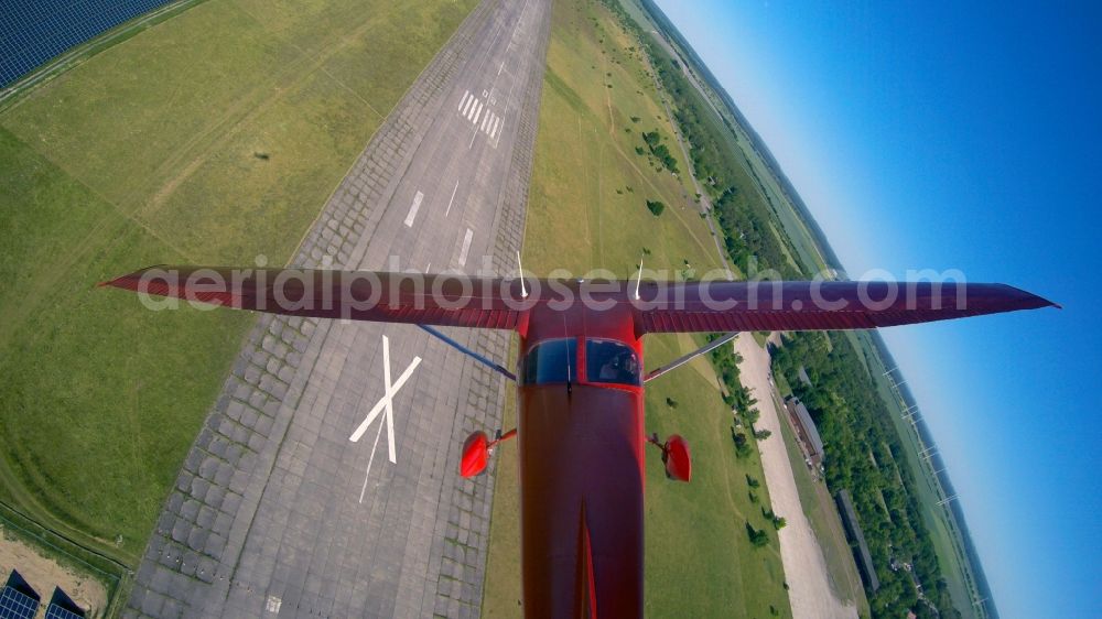 Werneuchen from above - Bright red Cessna 172 D-EGYC of the agency euroluftbild.de in flight over the airfield in Werneuchen in the state Brandenburg, Germany