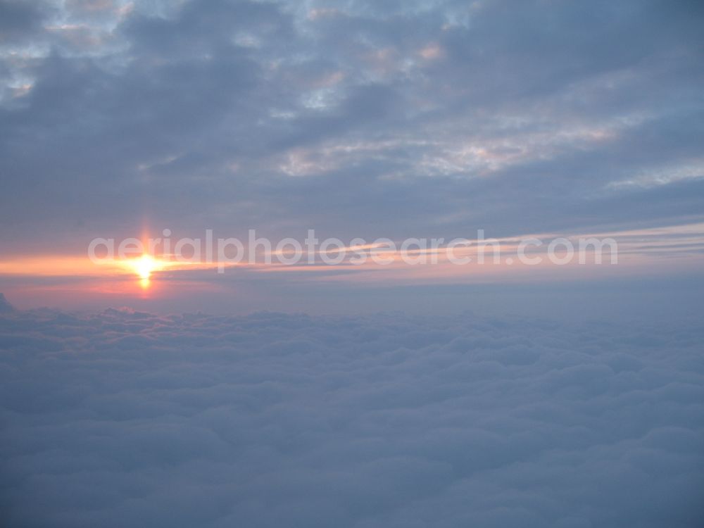 Buttenwiesen from the bird's eye view: Red sunlight between cloud formations in Buttenwiesen bavaria