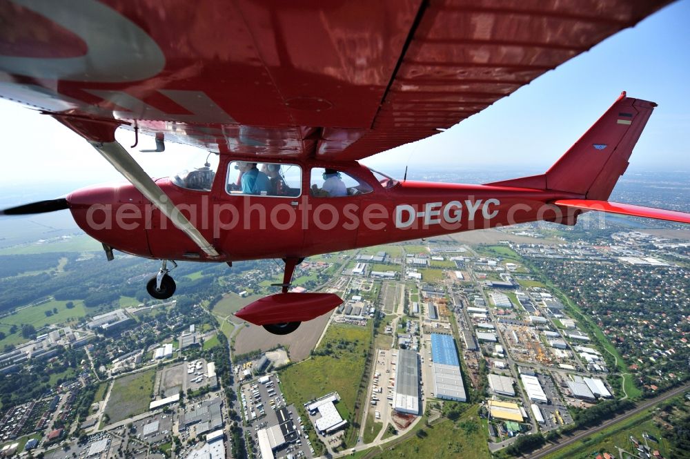 Aerial image Hoppegarten - Red Cessna F172H with sign D-EGYC Aircraft in flight over the airspace in the district Dahlwitz-Hoppegarten in Hoppegarten in the state Brandenburg, Germany