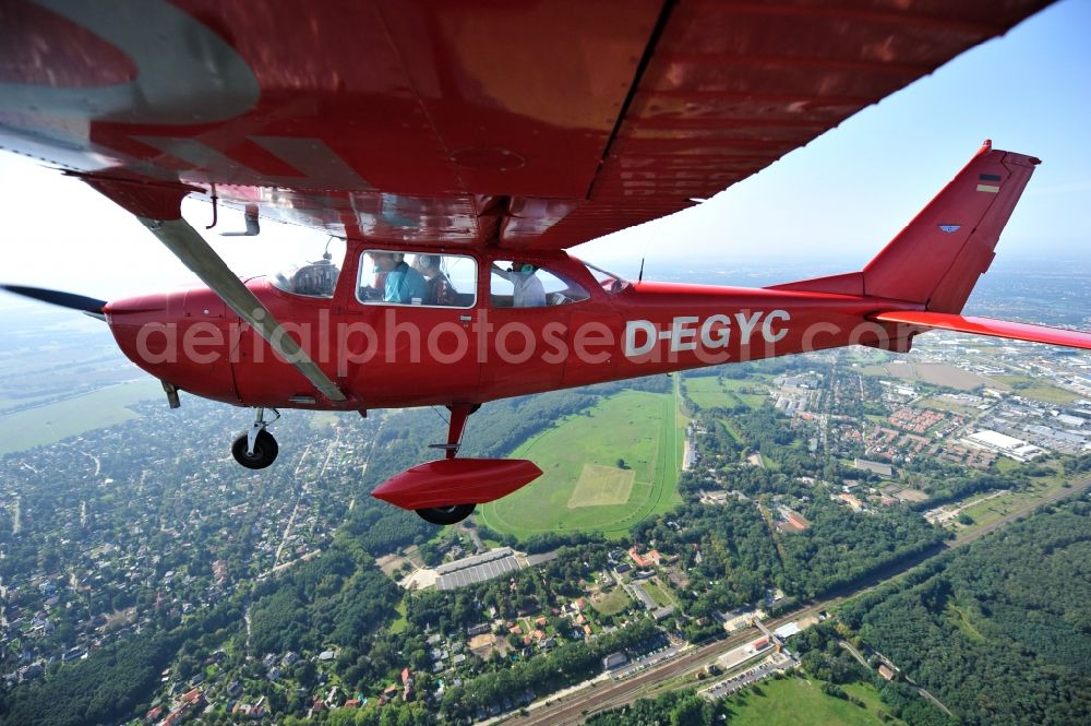 Hoppegarten from above - Red Cessna F172H with sign D-EGYC Aircraft in flight over the airspace in the district Dahlwitz-Hoppegarten in Hoppegarten in the state Brandenburg, Germany