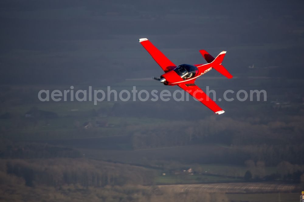 Hamm from the bird's eye view: Red Sport Aircraft Falco with the registration D-EKMK in flight in Hamm in North Rhine-Westphalia