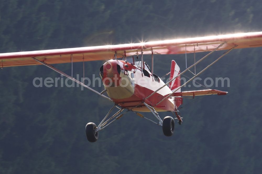 Bad Ditzenbach from the bird's eye view: Ultralight aircraft in flight above the sky Aircamper in roter Farbe mit der Kennung F-JRRL in Bad Ditzenbach in the state Baden-Wuerttemberg