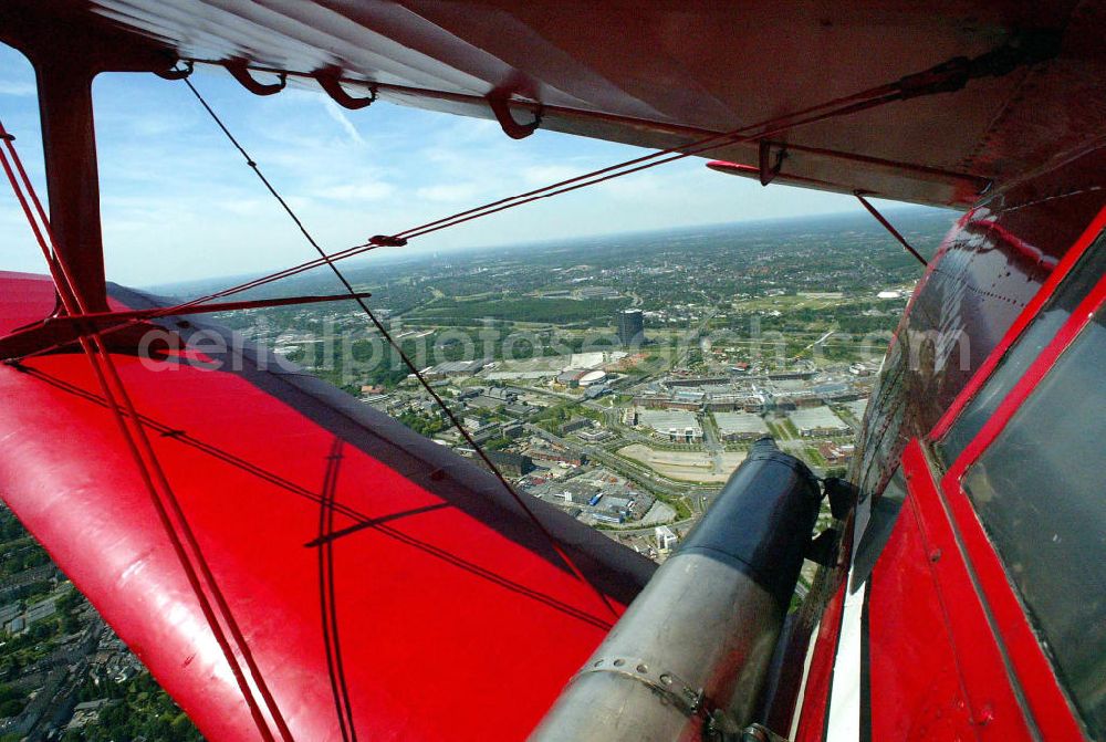 Oberhausen from the bird's eye view: Rundflug mit einem Doppeldecker- Flugzeug vom Typ Antonow AN-2 über dem Centro- Einkaufzentrum Oberhausen. Die AN-2 ist der größte noch fliegende Doppeldecker der Welt. Flight with a double-decker aircraft Antonov AN-2 above the Centro Shopping Centre Oberhausen. The AN-2 biplane flying still the largest in the world.