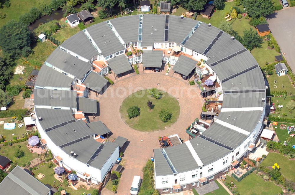 Dessau-Roßlau / OT Meinsdorf from the bird's eye view: Blick auf die Wohnanlage Rundling in Meinsdorf. Meinsdorf ist ein Stadtteil von Dessau-Roßlau in Sachsen-Anhalt. Die Stadt ist bei der Kreisreform am 1. Juli 2007 aus Dessau und Roßlau (Elbe) entstanden. Der Rundling entstand Anfang der Neunziger Jahre im Zuge des Projektes Europadorf - bauen und wohnen in Europa. Der Rundling liegt kreisförmig am Jeanne-d'Arc-Ring, der innere Bereich misst eine Breite von ca. 30 m. Die Häuser ähneln einem Kuchenstück und flachen zum Inneren hin ca. 1 m ab. Kontakt: Stadt Dessau-Roßlau, Der Oberbürgermeister, Redaktionsteam, Pressestelle, Zerbster Str. 4, 06844 Dessau-Roßlau, 0340/2042113